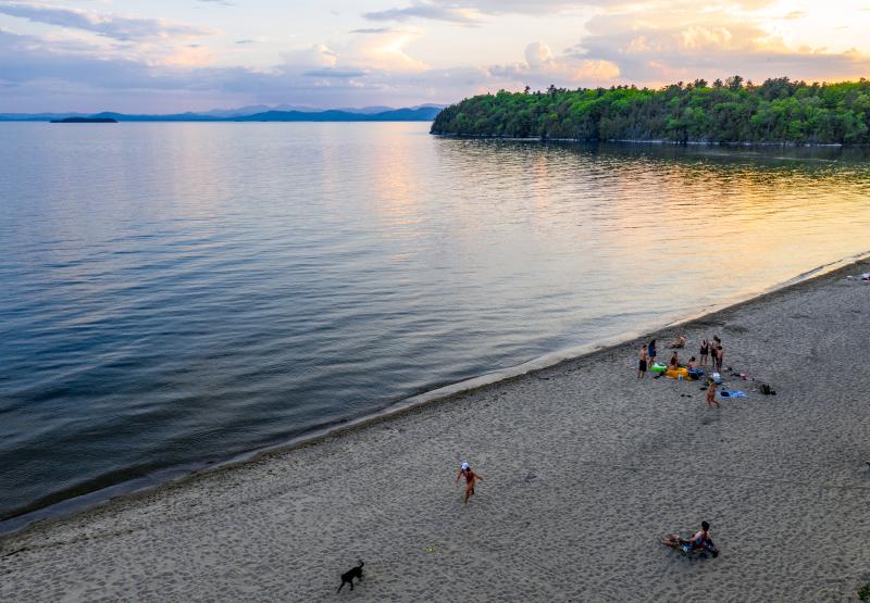 calm lake with beachgoers