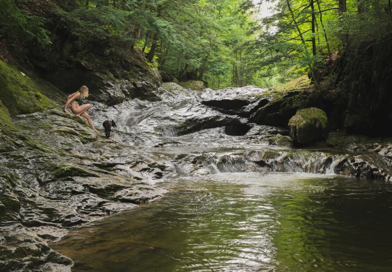 Lady swimming in a stream