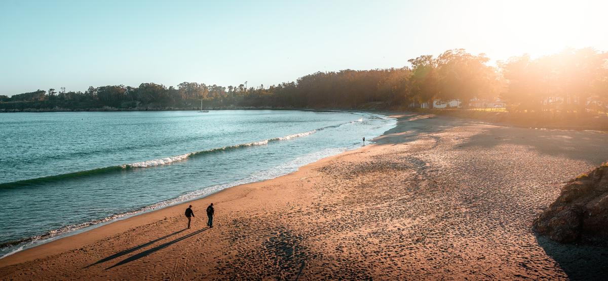 Couple walking on beach in San Simeon