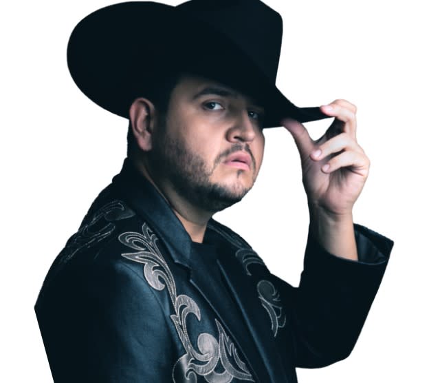 Musical artist Eden Munoz poses for a photo wearing a black felt cowboy hat and western jacket