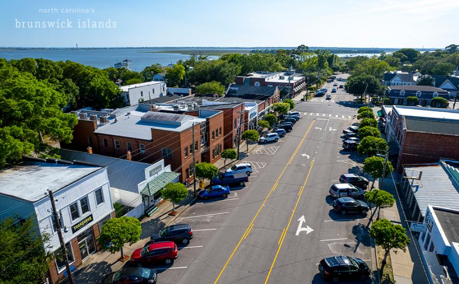 aerial photo of downtown street with water in the background