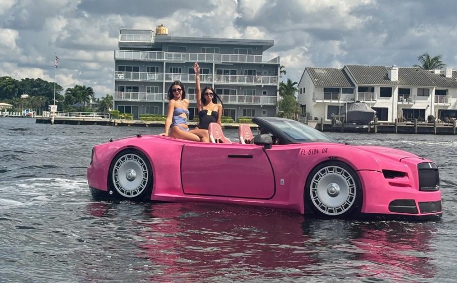 Two ladies riding in a hot pink Jetcar on the Intracoastal Waterway in Pompano Beach