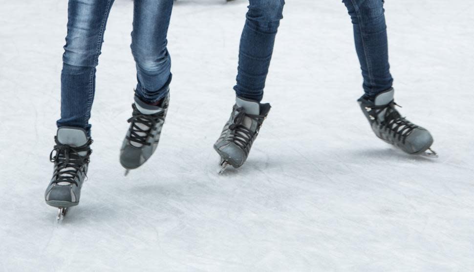 Close-up of ice skates on an ice rink (photo: CincinnatiUSA.com)