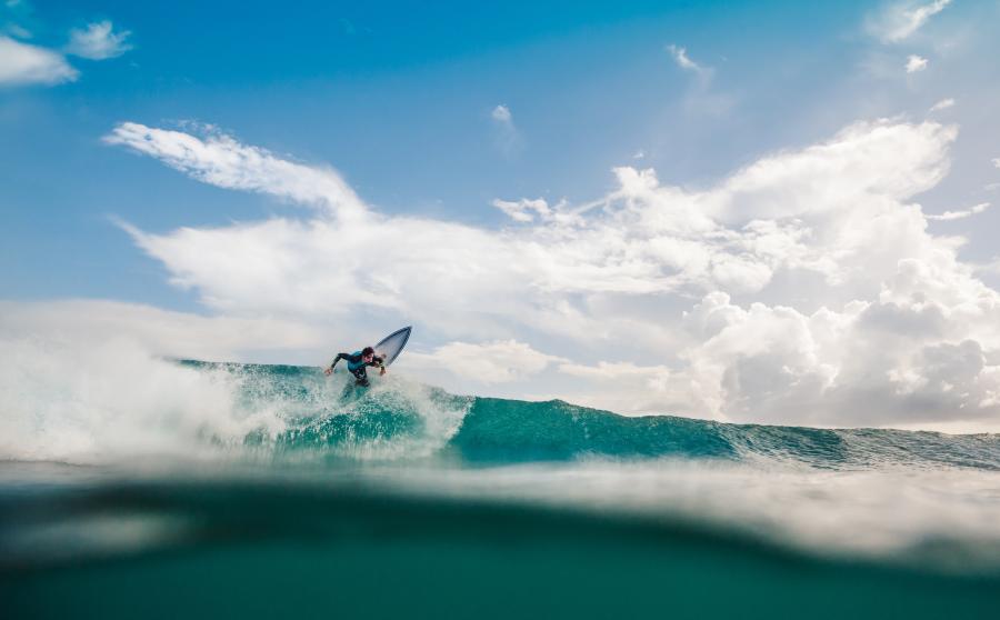 Surfer catching a wave out on the Pacific Ocean