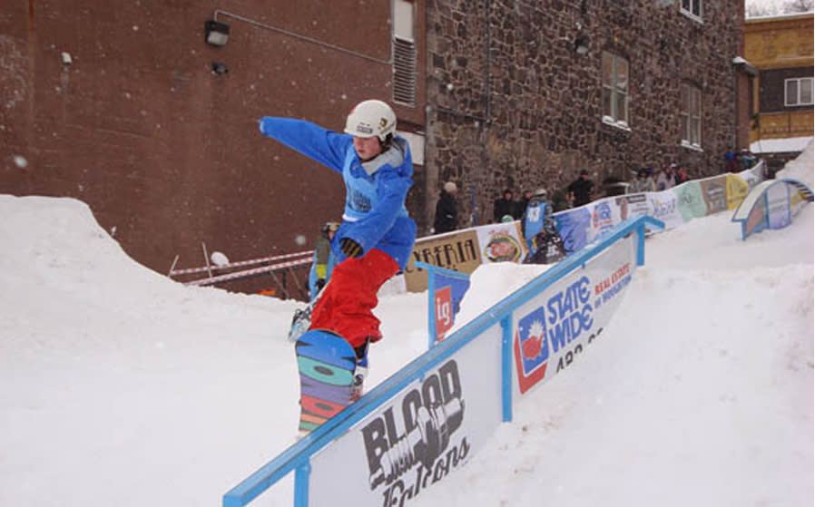 Snowboarder rides rail at Jibba Jabba