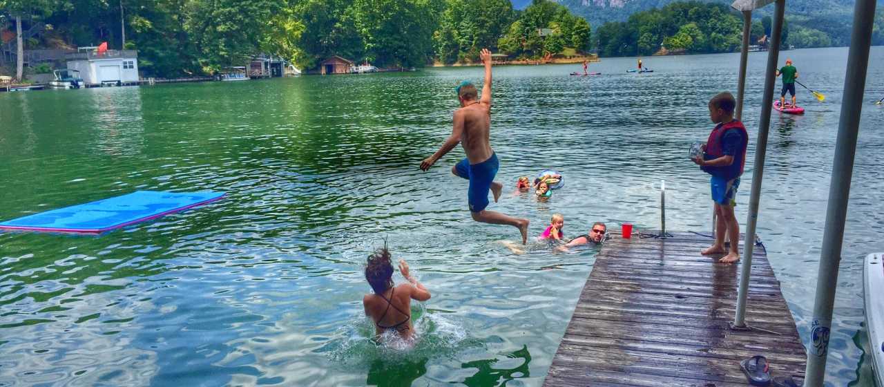 A group of friends jumping into Lake Lure, NC}