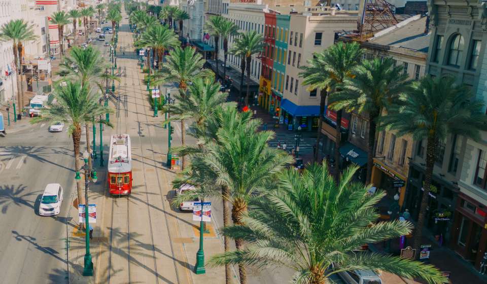 Streetcars Roll Along Canal Street - Downtown New Orleans
