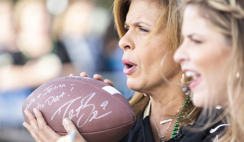 Hoda with a football signed by Drew Brees