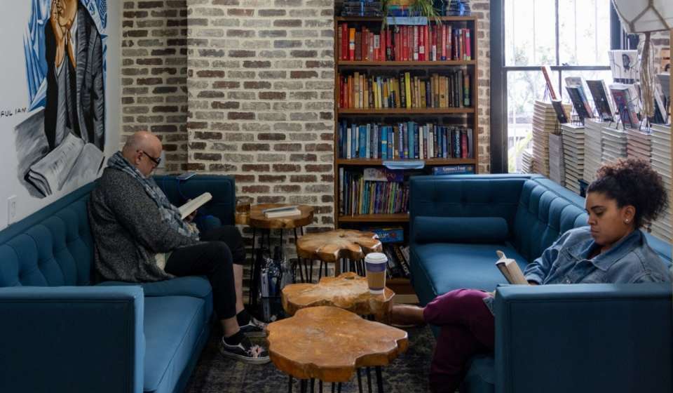 People sitting on couches and reading inside Baldwin & Co.