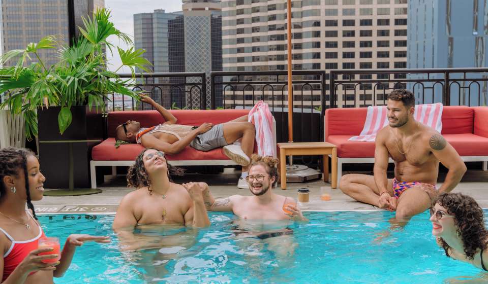 Friends hang out a the pool at the Virgin Hotels New Orleans