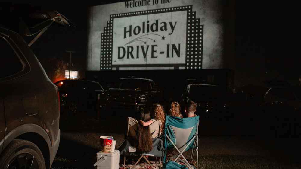 Family watching a Drive IN theater IN Santa Claus, Indiana