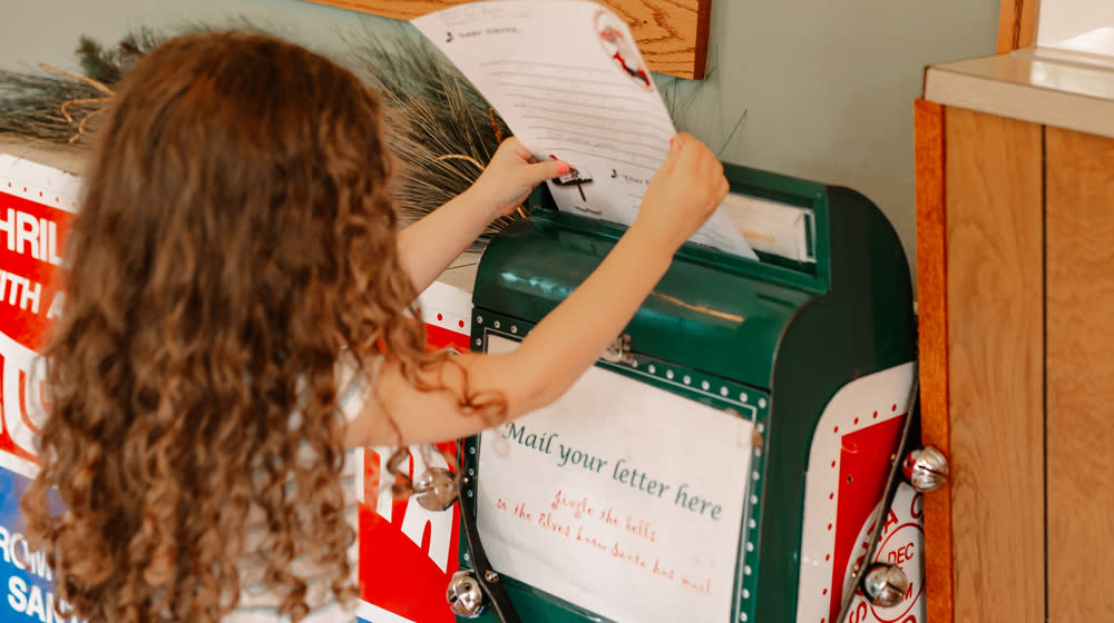 Girl sending letter to Santa via Mail box IN Santa Claus Indiana