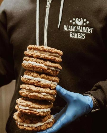 A man carrying a stack of oatmeal pies