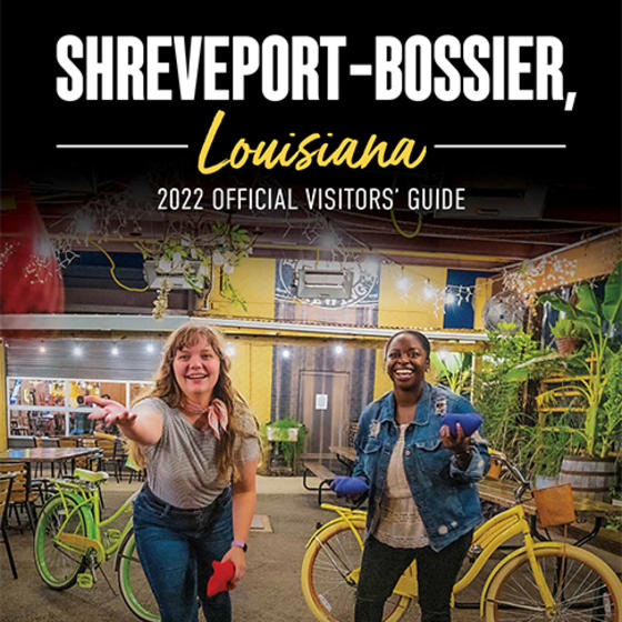 2022 Visitors' Guide Cover Cropped - Two women tossing beanbags in a beergarden