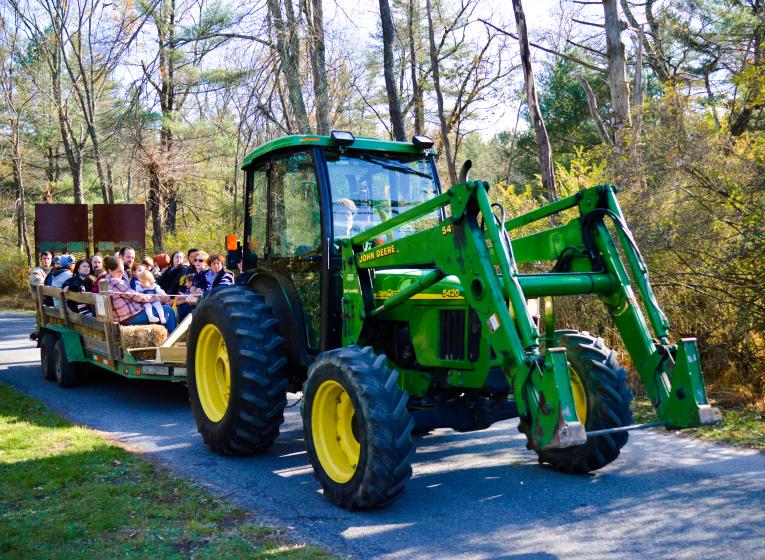 John Deere tractor pulling a trailer of people at the Fall Furnace Festival