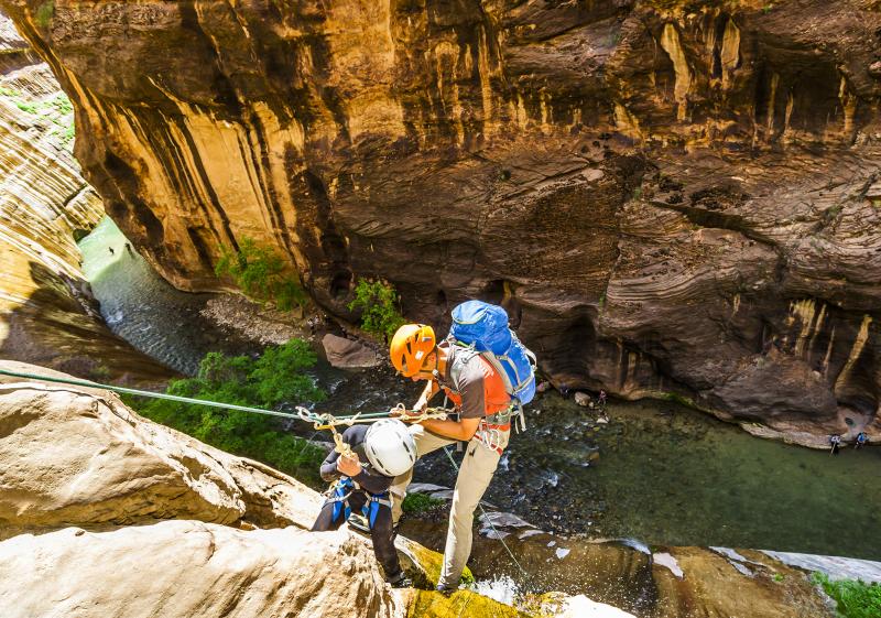 Father and son on Zion adventure, canyoneering in Mystery Canyon into the Virgin River Narrows, Zion National Park, Utah