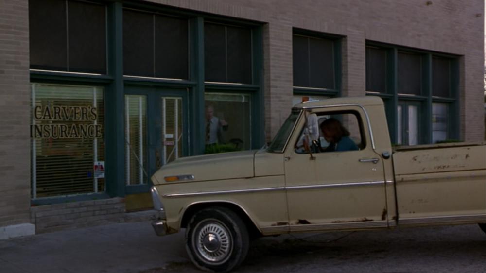 What's Eating Gilbert Grape Screengrab, showing an old white truck parked in front of Carver's Insurance building
