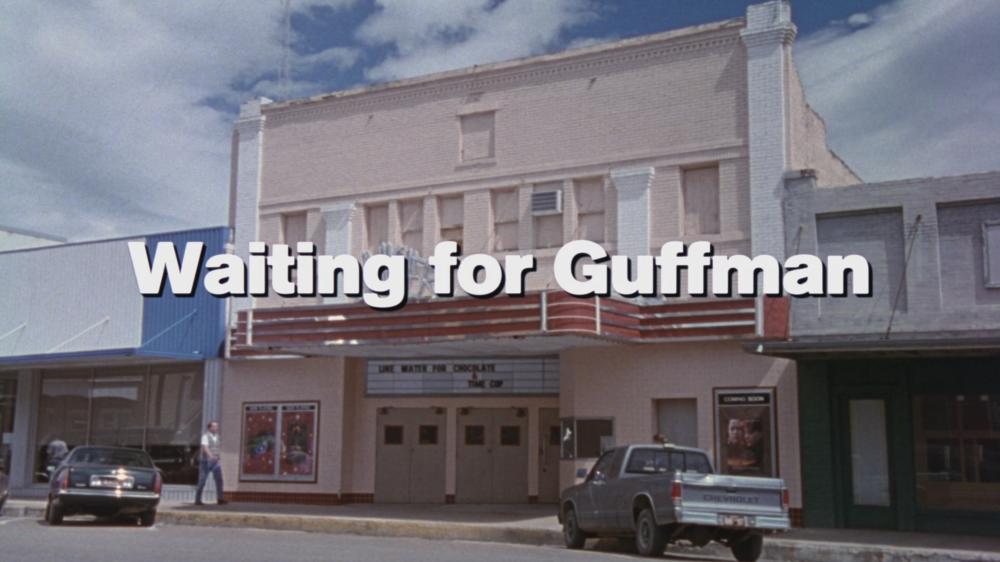 Film screengrab showing a title card reading Waiting for Guffman in front of an old theatre building