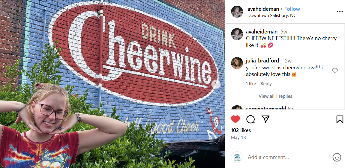Girl posing in front of Cheerwine mural