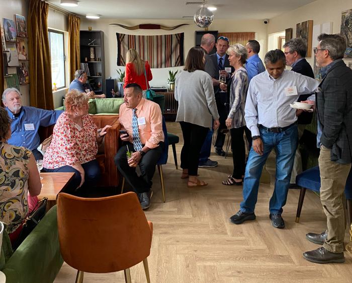 A group of people network at the April 2023 Business Exchange