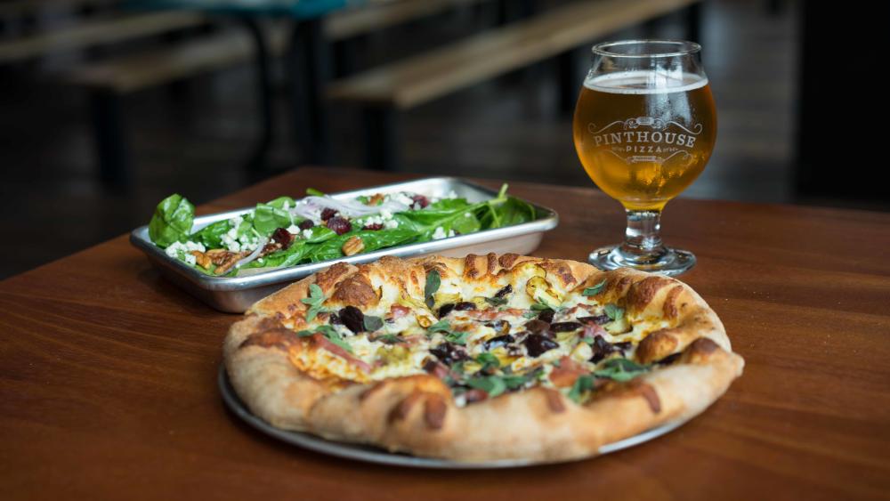 Personal size pizza, salad and tulip glass of beer from Pinthouse Pizza