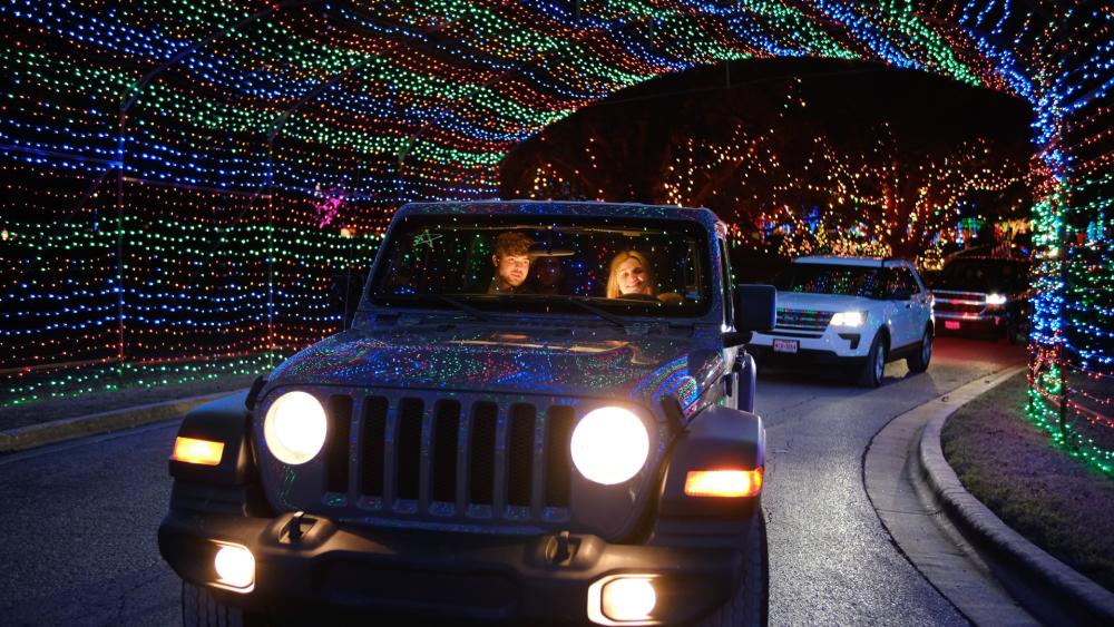 Cars driving through light tunnel at Austin Trail of Lights