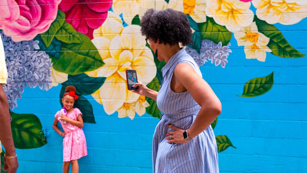 Family posing at Walt Whitman Mural downtown