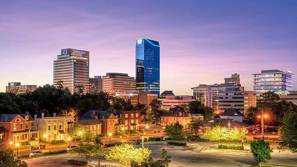 Sun setting behind the skyline of downtown Lexington.