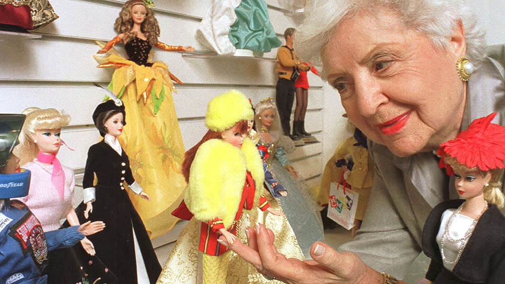 Ruth Handler poses with examples of her creation, the Barbie doll, at its 40th anniversary celebration at FAO Schwarz in New York in 1999. (Larry Lettera/Feature Photo Service/Newscom)