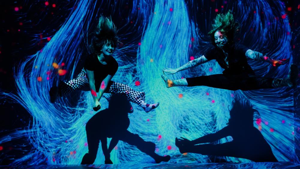 Two girls jumping in interactive museum