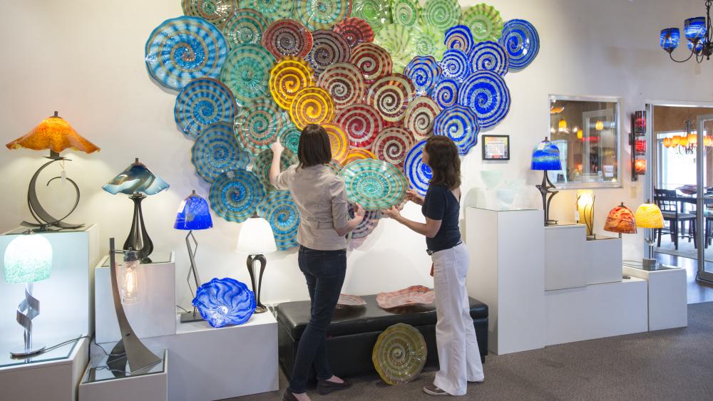 Two women looking at glass platters