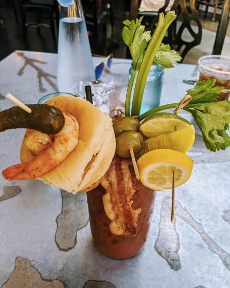 Loaded bloody mary with bacon, shrimp, olives, asparagus and lemons and limes