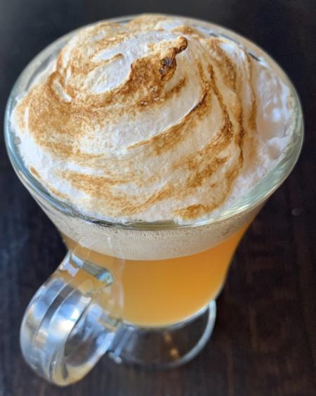 Hot spiked cider cocktail with toasted Cinnamon foam