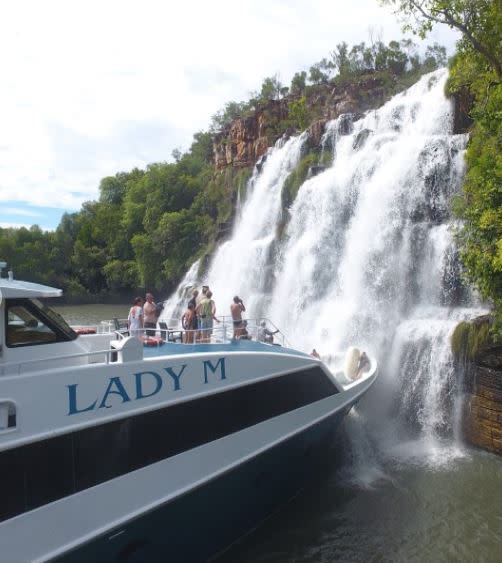 Lady M Luxury Cruises passengers under the spray at King Cascades on the Kimberley Coast
