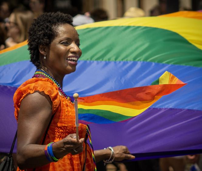 A black woman carries a rainbow flag in the Annapolis Pride Parade