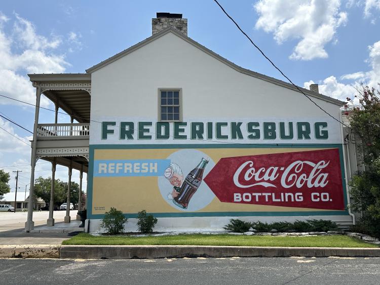 A historic Coca Cola Mural on the side of a building