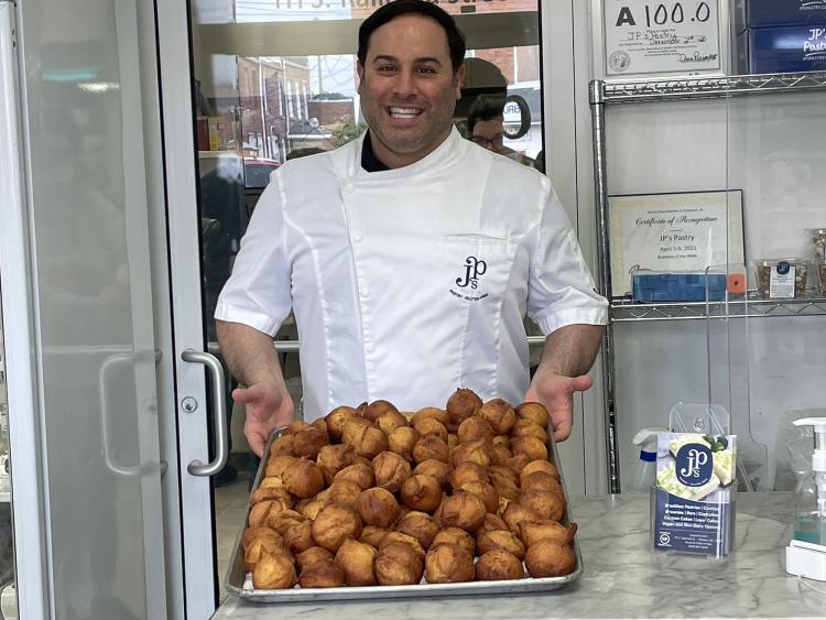 JP's Pastry Owner Joe Parker Poses with a Tray of Glueten-free Muffins