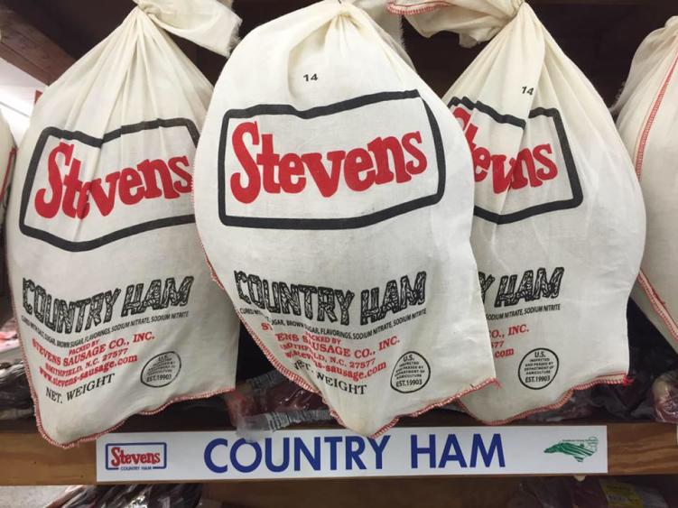 Cloth-covered Country Hams from Stevens Sausage Hanging in a Store