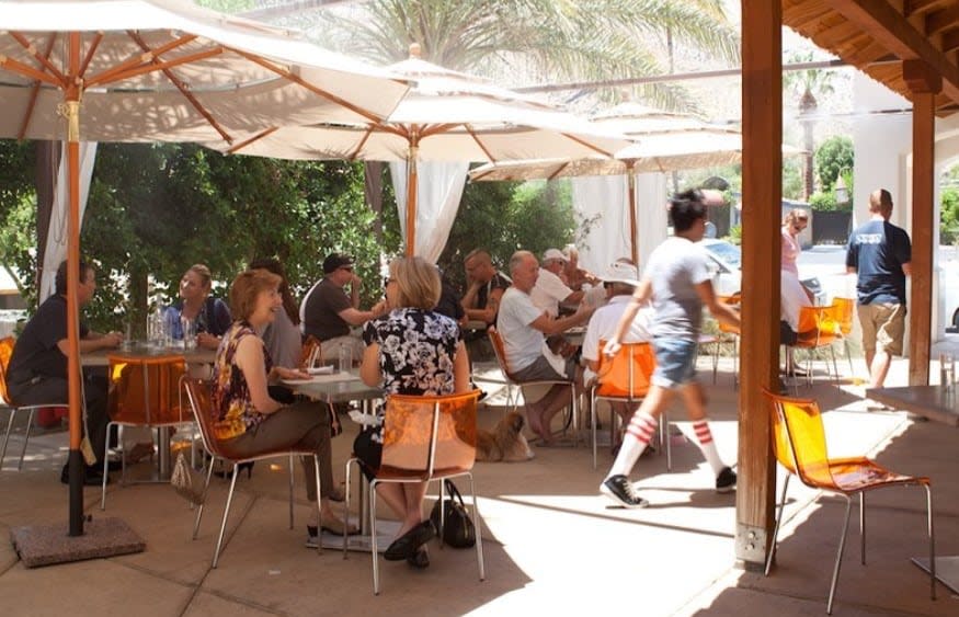 People eating at the outdoor patio at Cheeky's in Palm Springs