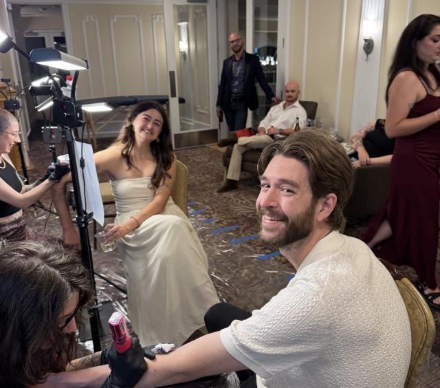 Wedding couple getting tattoos together at their pre-party at the Stanley Hotel Pavilion