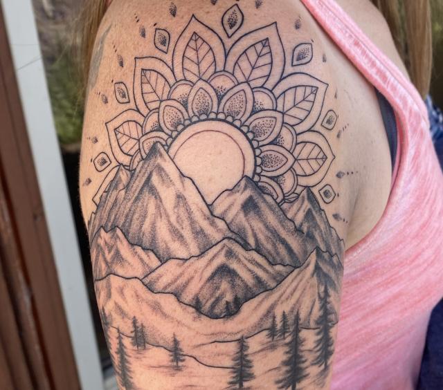 Mountain scene tattoo with mandala