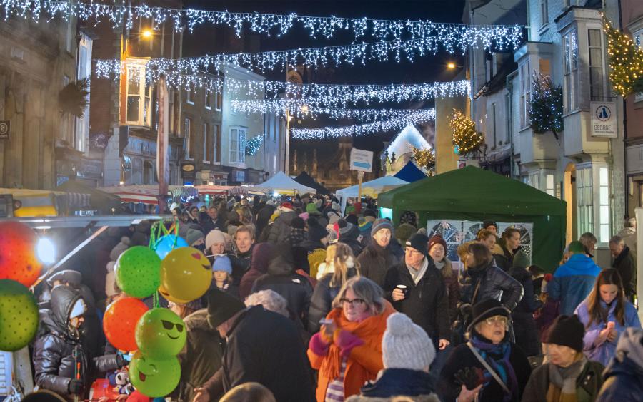 Malmesbury at Christmas, a festive scene with Christmas lights and market stalls