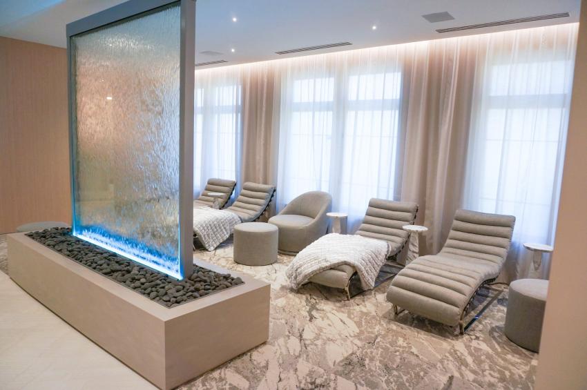 Room with reclining chairs and water sculpture