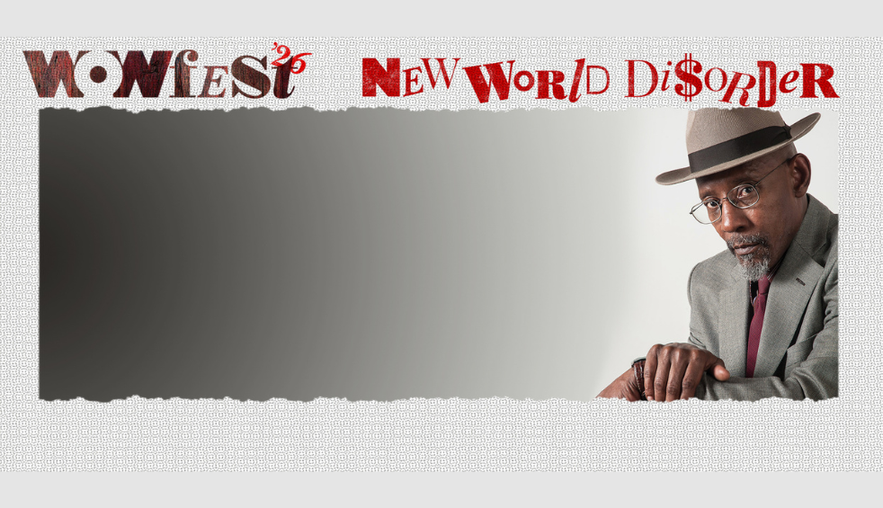 A person wearing a grey suit and a grey hat on a grey background. It says Wowfest26 New World Disorder across the top.