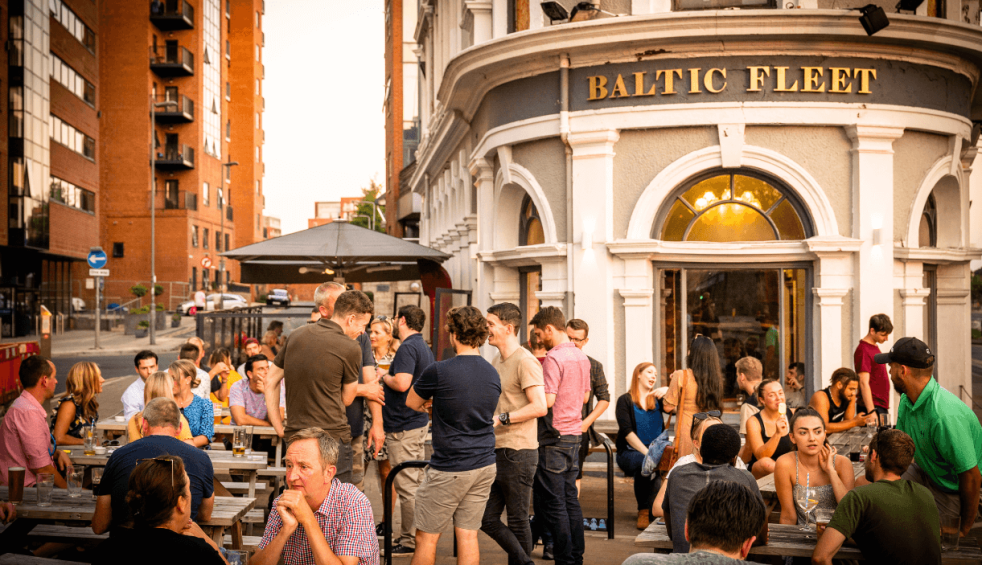 People sitting outside the Baltic Fleet pub a 19th Century Pub at golden hour