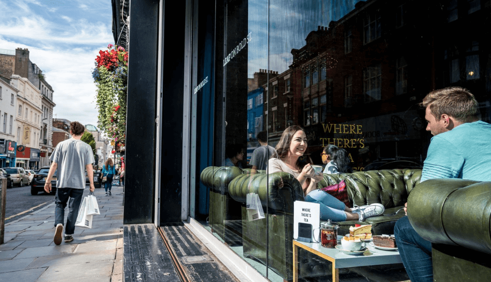 Leaf tea shop on bold street with people sitting in the the window.