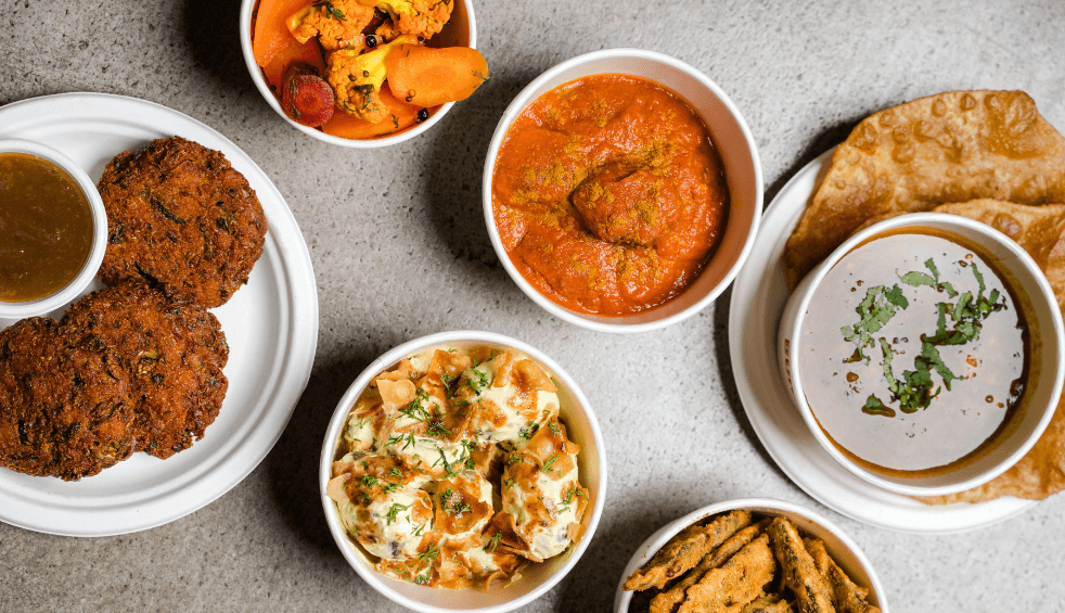 A birds eye view of food from the Bundobust menu on a table.