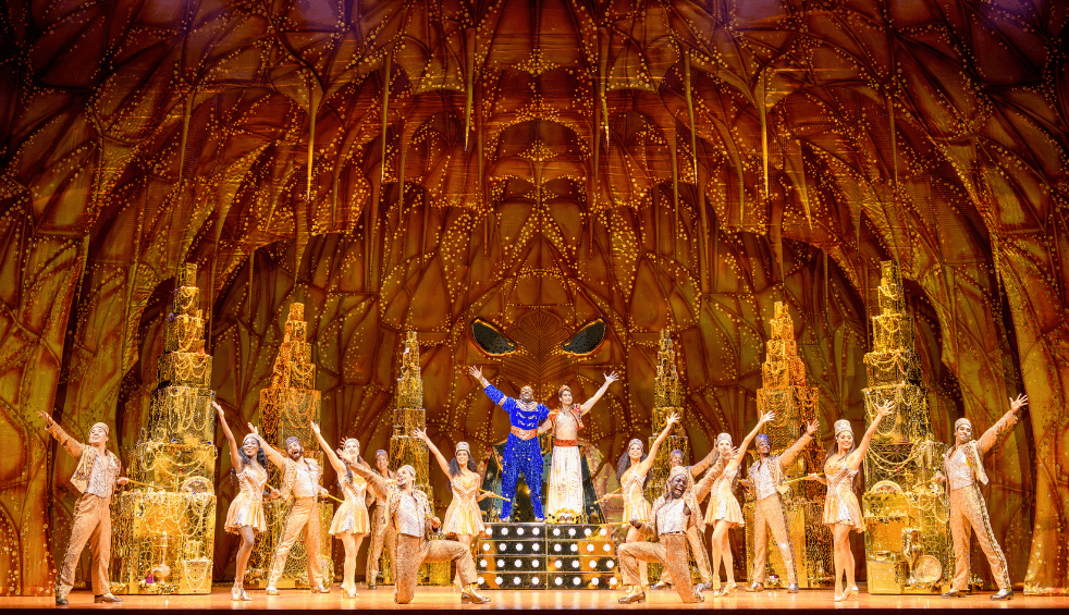 Cast from the stage show Aladdin on a stage.