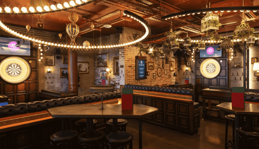 Inside Flight Club with dart boards and tables and chairs.
