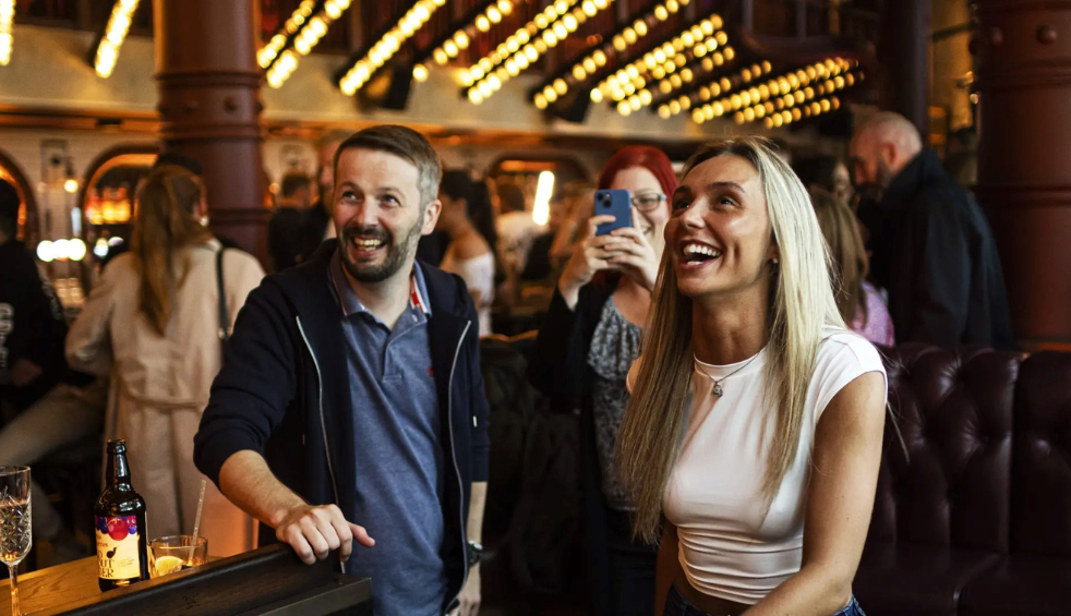 People smiling and laughing in Flight Club